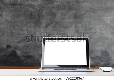 Laptop Computer for business education,background blur of blackboard.copy space.