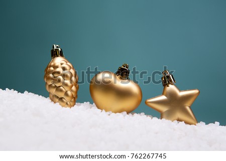 Christmas card - white and glass balls and Christmas toys on a snow slide. Close-up, beautiful picture. Green background, white, red, blue, green.