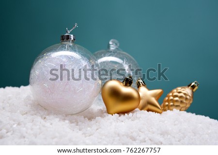 Christmas card - white and glass balls and Christmas toys on a snow slide. Close-up, beautiful picture. Green background, white, red, blue, green.