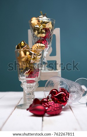 Christmas card - golden and red balls and Christmas toys. Close-up, beautiful picture. White wooden background