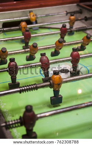 Table football is a classic table-top game, also called fuzboll or foosball and sometimes table soccer.  Royalty-Free Stock Photo #762308788
