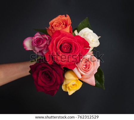Small bouquet of roses in hand from above, top view and isolated