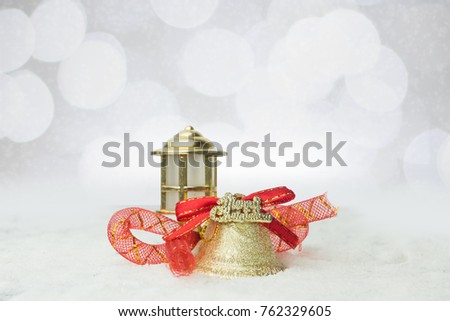 christmas golden bells with red ribbons on the snow