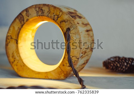 wood lamp handmade in front of a white wall