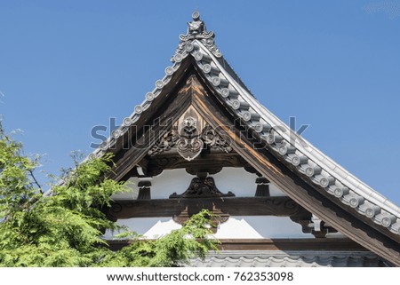 Details of traditional wooden Japanese temple roof in park in Kyoto, Japan.