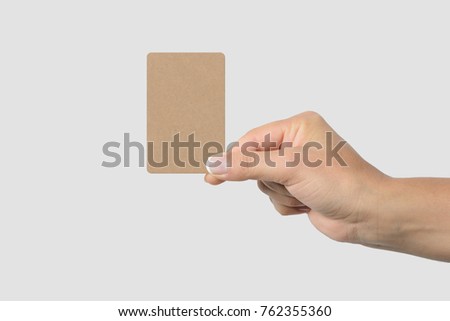 Mockup of female hand holding a Kraft Paper Business Card isolated on light grey background. Rounded corner, size 85 × 55 mm.