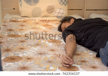 Portrait of man lay down in bed and get to sleep after tried from work