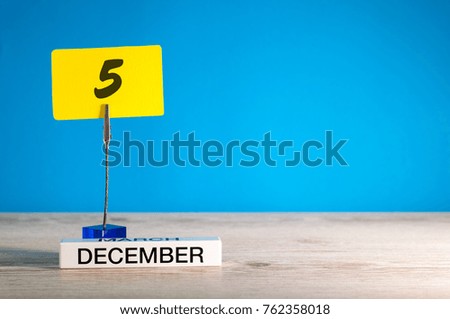 December 5th mockup. Day 5 of december month, calendar on blue background. Winter time. Empty space for text