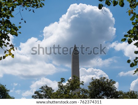 Washington Monument in Washington DC Capital City, on a bright day with blue sky and clouds in the background