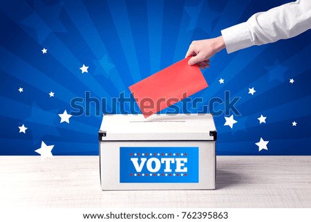 Voting hand with ballot and wooden box