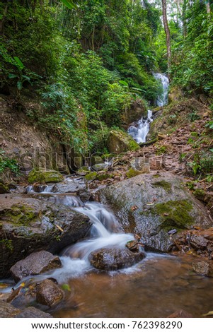 Deep forest waterfall at Doi Hua Mae Kham Waterfall in Chiang Rai, Thailand.