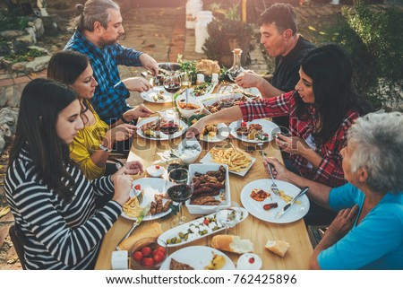 Family dining outdoor at backyard patio Royalty-Free Stock Photo #762425896