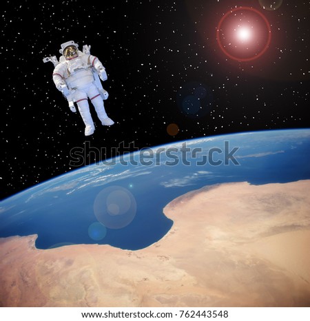 Astronaut against the  earth. The elements of this image furnished y NASA.
