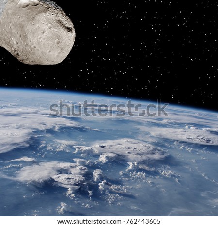 Asteroid aproaches to the cloudy earth. The elements of this image furnished by NASA.