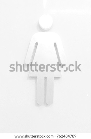 Female - male symbol in front of toilet. 