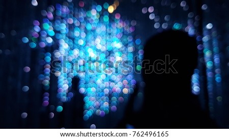 a blurred picture of a man on a colorful light.
