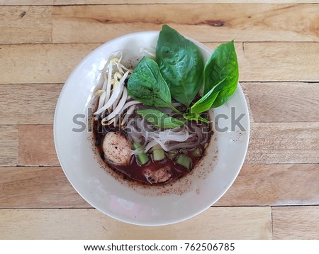 Stir-Fried noodle with pork , meet ball , basil leaves and sprouts , Thai style Royalty-Free Stock Photo #762506785