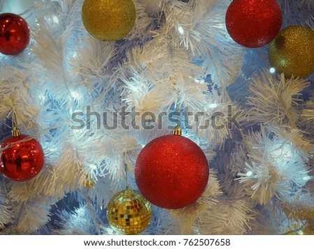Many golden and red ornament balls on white Christmas Tree. Can use for background or add text.