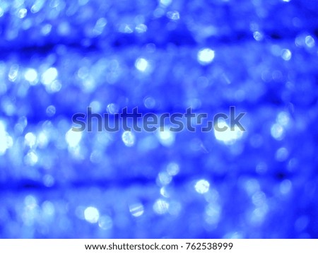 Decorative Abstract out of focus lights with abstract background of Blue. Good for Christmas and New Year celebrations. 
