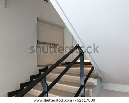 modern minimalist style stairs with night lighting and black steel handrails in empty modern office building interior