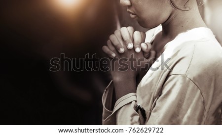 Hand girl praying in the church in vintage tone, Hands folded in prayer concept for faith, spirituality and religion, Coronavirus quarantine concept, food children donation  Royalty-Free Stock Photo #762629722