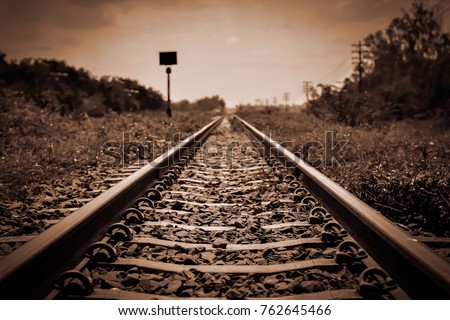 Vintage railroad tracks sepia color in grunge and retro style and old picture  Royalty-Free Stock Photo #762645466