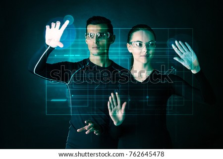 Couple working with futuristic display, innovation, future concept, abtract glowing outline