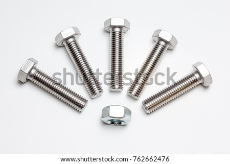 these five bolts and an nut are on a white background