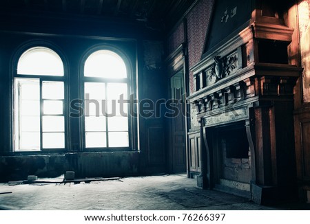Fireplace at old ruins with magic light through windows
