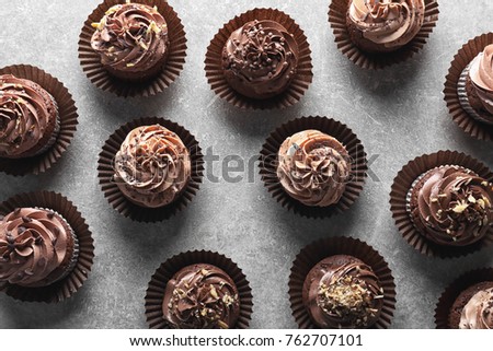 Tasty chocolate cupcakes on grey background