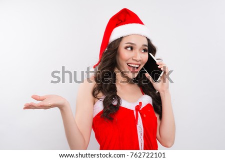 Christmas woman listening to smartphone on white.