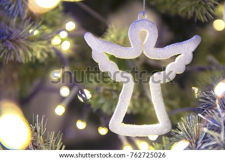 white figure of a Christmas angel on a tree Royalty-Free Stock Photo #762725026