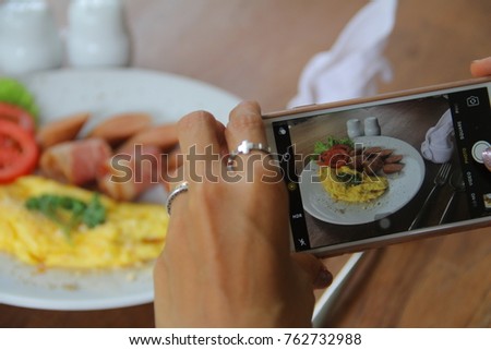Taking picture of food with mobile phone.