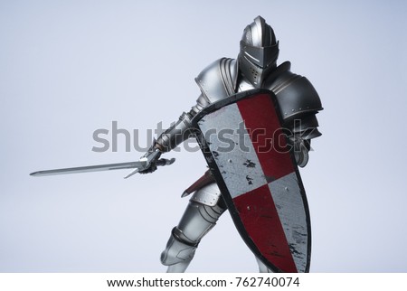 Knight with sword and red checkered shield on isolated background Royalty-Free Stock Photo #762740074