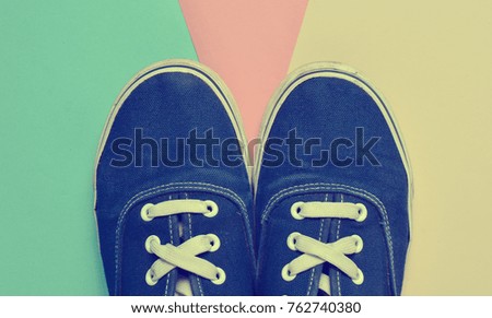 Fashionable blue sneakers on a pastel colorful background. Trend of minimalism. Top view.