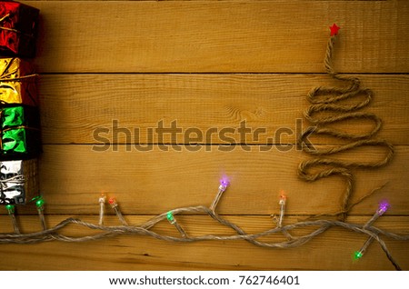 Christ tree,gift box and blinker on wooden background with copy space.