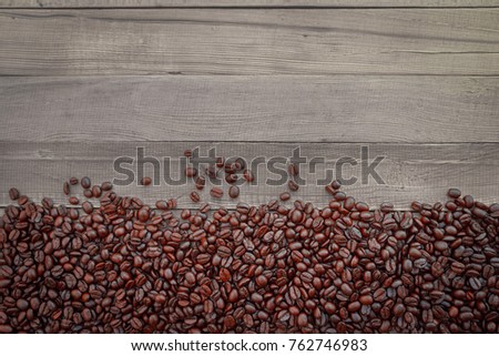 Coffee bean on wood background with copy space.Top view.