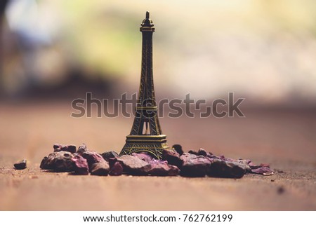 Miniature/Toy of the Eiffel tower on a Brown background. The decoration and the memory of the journey. Part Of Paris. France