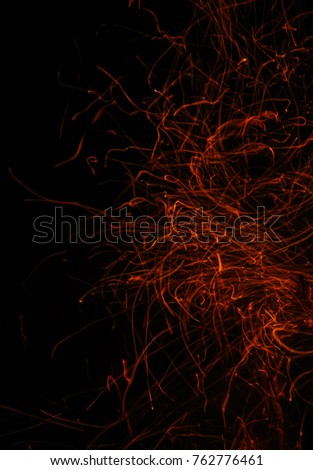 A close-up photograph of particle sparks from a bonfire. This photo was taken in Brisbane, Australia. 