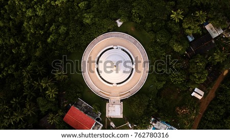 Peace pagoda tower in tropical palms sri lanka aerial shot