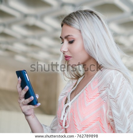 woman checking her phone for new messages or emails. technology social network addiction. modern easy and fast communication concept