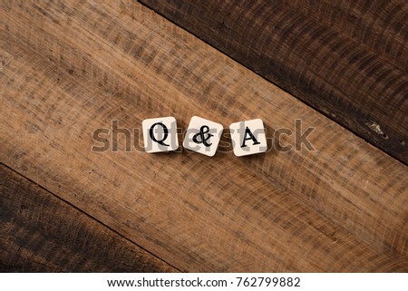 Questions and Answers Q&A concept. Q&A letter on alphabet tiles on wooden table