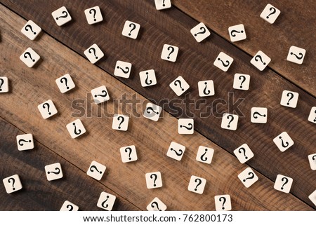 Question mark on alphabet tiles. question mark on wooden table background Royalty-Free Stock Photo #762800173