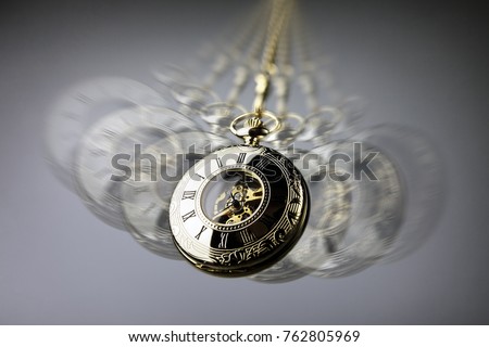 Hypnotism concept, gold pocket watch swinging used in hypnosis treatment Royalty-Free Stock Photo #762805969