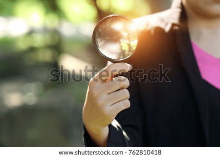 businesswoman holding magnifying glass, idea for business innovation and inspiration concept using as background
