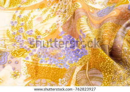 texture, background, pattern. Fabric silk abstract pattern. On beige fabric blue flowers, brown pattern A contemporary multipurpose upholstery and drapery fabric in colorful floral design of navy blue