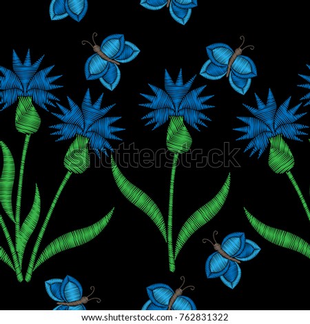 Seamless pattern with blue flower with butterfly embroidery stitches imitation on the black background. Embroidery floral background.