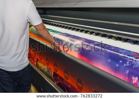 Large-format printing machine in the printing house. Industry Royalty-Free Stock Photo #762833272