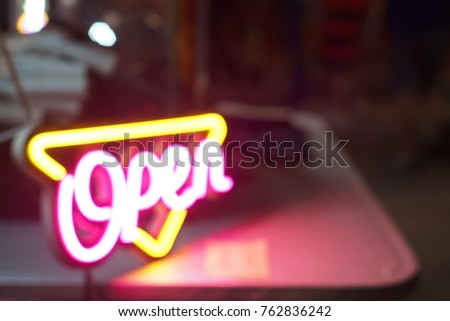 A blur neon open sign with  copy space on the right.