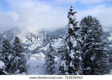 Winter landscape in the Alps. Snow-covered trees, mountains in the background